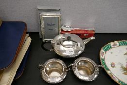 A silver plated three piece tea set having engraved decoration and sundry items