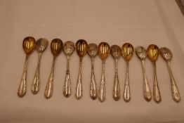 A set of twelve silver gilt 800 mustard spoons, marked Vienna Austria 800, 11.38ozt approx