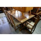 A reproduction oak refectory table and a set of six matching chairs