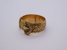 9ct yellow gold buckle ring, with all over floral decoration, size R, 5.5g approx, marked 375