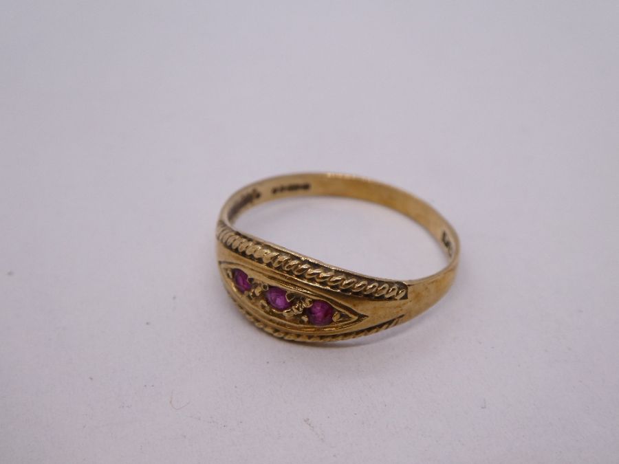 9ct yellow gold gypsy ring set with three small rubies, marked 375, size P, 1.7g approx. Gold conten