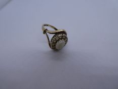 9ct yellow gold dress ring with central white opal surrounded clear stones, Split shoulder band, mar