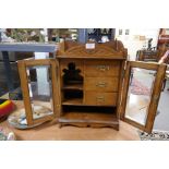 An early 20th century oak tobacco cabinet having three drawers