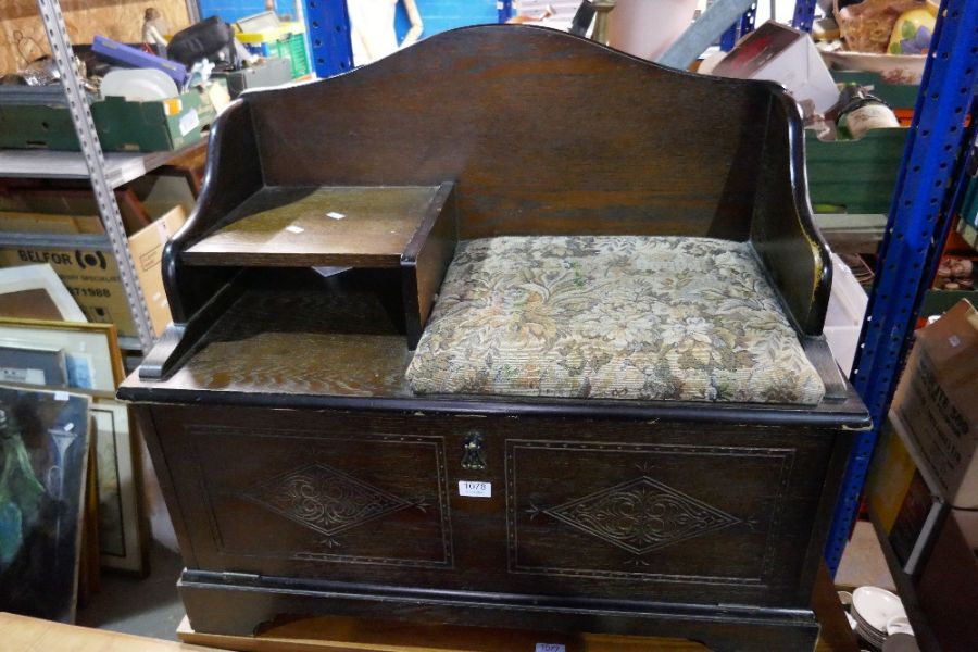 A reproduction oak hall bench having cupboard base