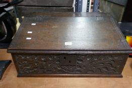 An antique carved oak sloping box, circa 1800, 65cms