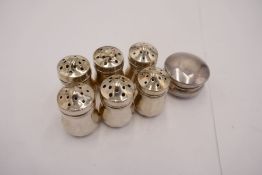 A set of six sterling silver miniature pepper shakers with decorative design. Ornate items stamped S