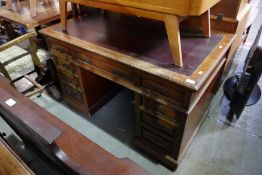 A late Victorian mahogany twin pedestal desk having nine drawers