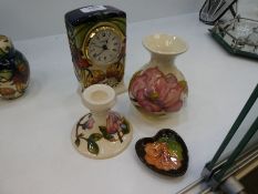 A modern Moorcroft mantle clock and three other Moorcroft items