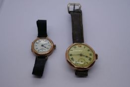 Two antique 9ct gold cased wristwatches, one on leather strap, the other a fabric example. Both case