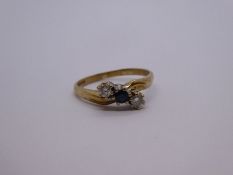 9ct yellow gold crossover design ring with central Sapphire flanked two diamonds, each approx 0.10 c