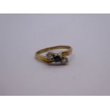 9ct yellow gold crossover design ring with central Sapphire flanked two diamonds, each approx 0.10 c