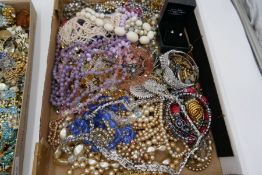 Two trays of vintage costume jewellery to include large quantity of brooches, pearl necklaces, bead