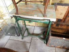 An old cast iron mangle by Ewbank and a cane chair