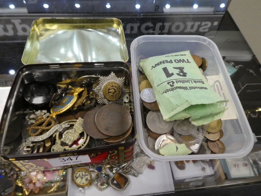 A tin containing military cap badges and pilot's wings and a quantity of coins, including a 1771 Rus