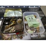 A tin containing military cap badges and pilot's wings and a quantity of coins, including a 1771 Rus