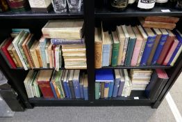 Four shelves and a suitcase of assorted books to include Beatrix Potter examples