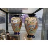 A pair of Japanese vases decorated figures in landscape