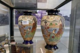 A pair of Japanese vases decorated figures in landscape