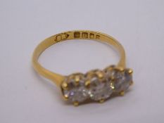 18ct yellow gold diamond trilogy ring, the central stone approx 0.40 carat, size N/O, carbon visible