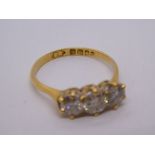 18ct yellow gold diamond trilogy ring, the central stone approx 0.40 carat, size N/O, carbon visible