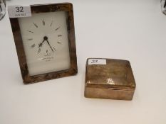 A silver rectangular framed clock by Kitney and Co, London, also with a worn silver cigarette box wi