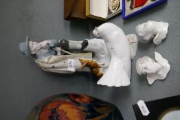 A German porcelain figure of man with dog, a Lladro dove and two Lladro angel heads