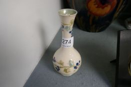 William Moorcroft, a small cream vase decorated berries, made for Liberty, 15cm approx. (small chip