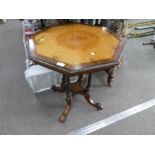 A 19th century Burr Walnut and ebonised octaganol table on fluted columns and splay legs, 61cms