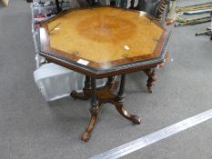 A 19th century Burr Walnut and ebonised octaganol table on fluted columns and splay legs, 61cms