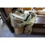 A WWII military camp bed with rolled mattress and canvas cover