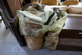 A WWII military camp bed with rolled mattress and canvas cover