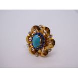 18ct yellow gold dress ring in the form of a flower head, inset with turquoise, blue and clear stone