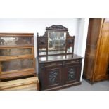 An early 20th century carved oak sideboard having mirror back, 137cms