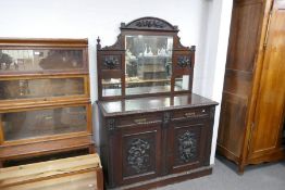 An early 20th century carved oak sideboard having mirror back, 137cms