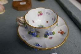 A 19th century, Meissen floral encrusted cup saucer