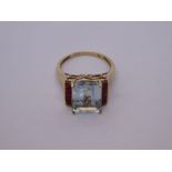 Modern aquamarine and ruby cocktail ring with large central rectangular cut aquamarine 11.5mm x 8.9m