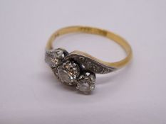 18ct and Platinum crossover diamond trilogy ring, central diamond approx 0.20 carat, with diamond ch