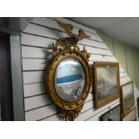 An old gilt convex wall mirror having Eagle Surmount