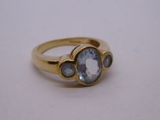 Modern 9ct yellow gold aquamarine trilogy, in a rubover setting, size O, marked 375, Birmingham, 200