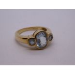 Modern 9ct yellow gold aquamarine trilogy, in a rubover setting, size O, marked 375, Birmingham, 200