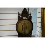 An early 20th century Admiral Fitzroy's barometer having carved oak case with circular dial