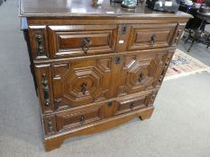 A 17th century oak chest, probably Jacobean, having three long drawers on later base with bracket fe