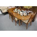 A 1970's G-PLAN extending dining table with a set of 6 matching chairs