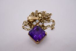 9ct yellow gold pendant set with large amethyst below three small white opals hung on an unmarked ye