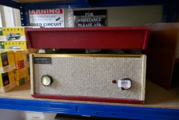 A vintage Dansette 'Challenge' record player with red cover