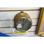 A brass ships bulkhead clock, the silvered dial marked C.B.Finter, East Sheen