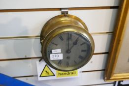 A brass ships bulkhead clock, the silvered dial marked C.B.Finter, East Sheen