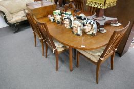 A 1970's G-PLAN extending dining table with a set of 6 matching chairs