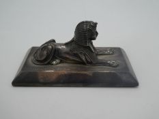 A silver engine turned paperweight with a Sphynx on top, raised pedestal border hallmarked Birmingha