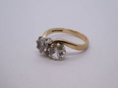 9ct yellow gold crossover design ring set with two clear stones, possibly sapphires? marked 375, siz